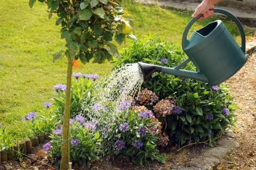 Garden maintenance worker pruning shrubs